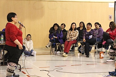 Quaqtaq's mayor Eva Deer speaks to women at the Arnaliat NipingIt conference in her community about its Aaqqitauvik healing centre. (PHOTO COURTESY OF SATURVIIT)