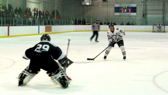 Darren Ikakhik of Rankin Inlet closes in on goalie Randy Qamaniq on a penalty shot in the last minute of play against Iqaluit, April 14. Ikakhlik scored on the play, earning his third goal of the game, and second star-of-the-game honours for netting all Rankin Inlet’s goals in a 6-3 loss. Qamaniq earned first star-of-the-game for his outstanding play in a victory that takes the Iqaluit Icemen to the Northern Hockey Challenge Cup finals. (PHOTO BY PETER VARGA)