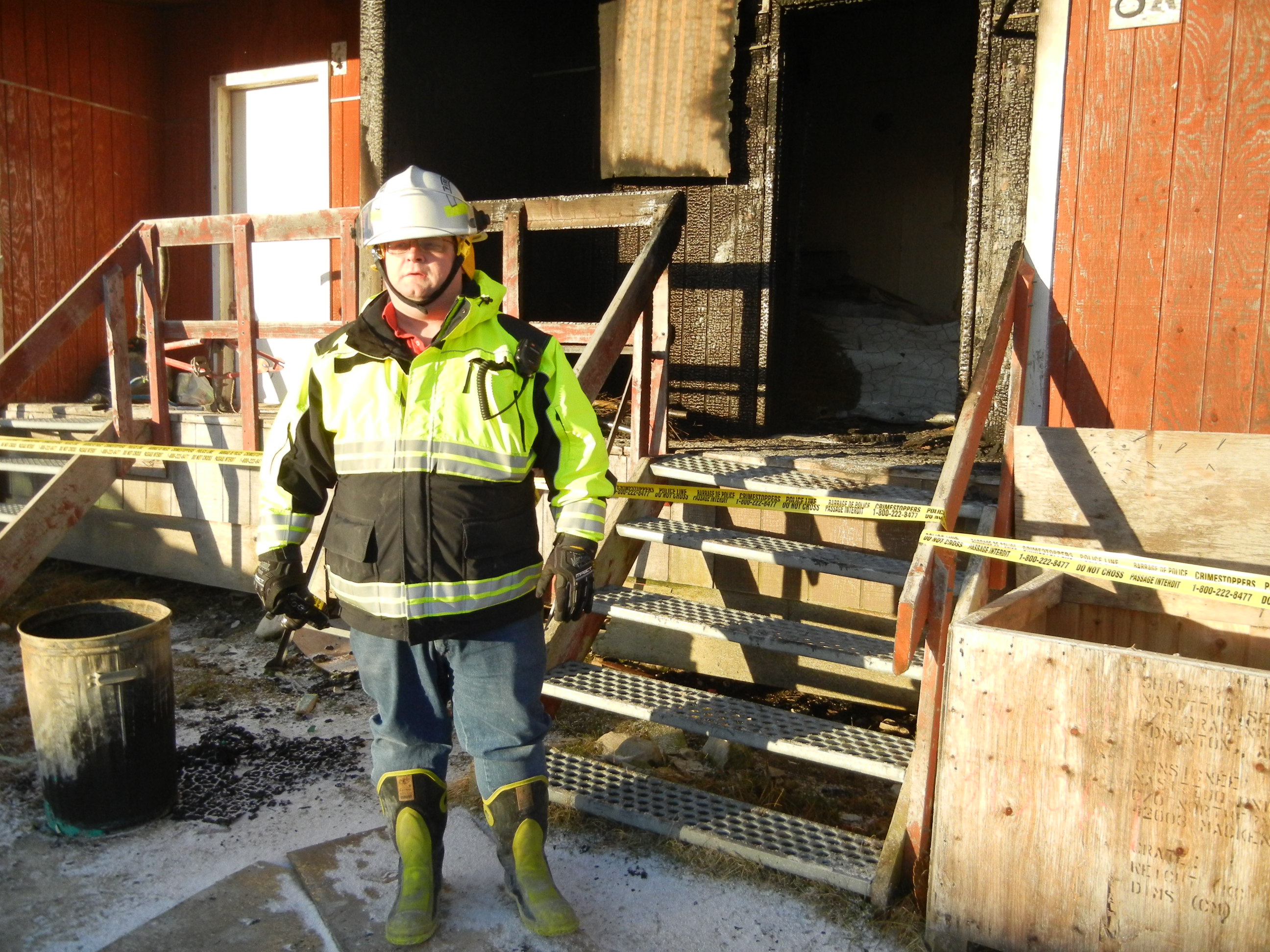 Cambridge Bay fire chief Keith Morrison, shown in front a duplex that burned last October in Cambridge Bay. (FILE PHOTO)