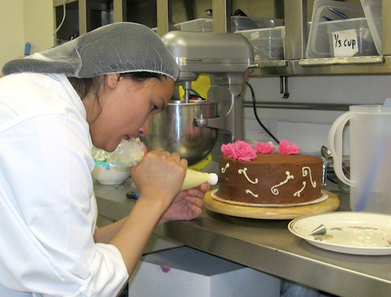Vayda Kaviok of Arviat decorates a cake she made in the final stage of a baking competition at the eighth annual Skills Nunavut Competition on April 23.
The Grade 12 student was one of seven who took part in the baking contest. Kaviok went on to win the baking contest, earning a chance to advance to the national Skills Canada competition in Vancouver this summer. Other competitions in this year's contest included cooking, carpentry, hairdressing, TV-video production and robotics.“We want to keep kids interested in trades and technology,” said Jennifer Patey, executive director of Skills Canada Nunavut. “We want to let them know what the opportunities are here in Nunavut.” (PHOTO BY PETER VARGA)