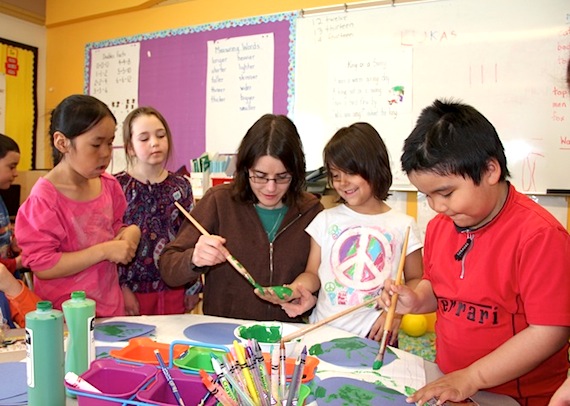 Students in Grade 1 class at Iqaluit’s Joamie School work on their April 22 “Earth Day promises” with green hand prints and their teacher. Some of their promises: picking up garbage, taking shorter baths or showers, walking or biking more often, recycling and reusing things, using less water and taking care of the animals. Earth Day is an annual event, celebrated on April 22, when events take place around the world to demonstrate support for environmental protection. (PHOTO BY SAMANTHA DAWSON) 