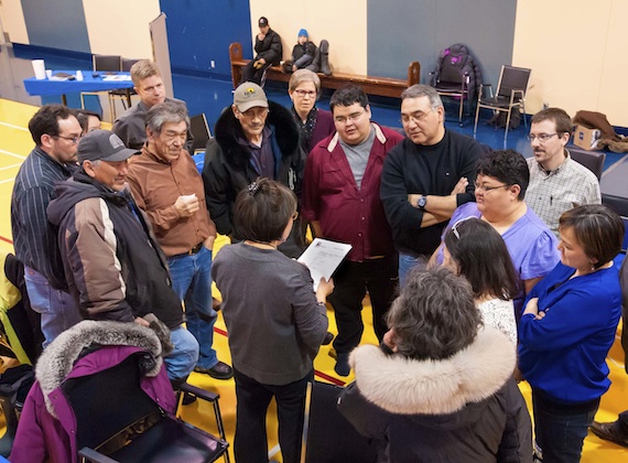 Jobie Tukkiapik, fourth from the right, surrounded by representatives from Nunavik organizations and their advisors, listens to Maggie Emudluk, the chairperson of the Kativik Regional Government, during a February consultation on the Parnasimautik plan in Kangiqsualujjuaq. (PHOTO BY PASCAL POULIN)