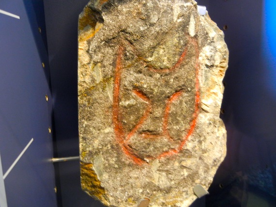 A cat-like face peers from a rock on display at the Pingualuit provincial park's visitors centre in Kangiqsujuaq. The engraving, collected in the 1960s  was sent to the Museum of Civilization (then the National Museum of Man) and later returned to the community, came from the nearby island of Qajartalik, where, on a 120-metre-long kayak-shaped ridge, are what some have dubbed “devil’s faces.