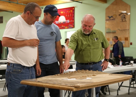 During the CHARS June 11 evening community consultation, Donald McLennon, head of monitoring science on the project, talks about the CHARS design to two of the 30-plus people who attended the session. (PHOTO BY RED SUN PRODUCTIONS)