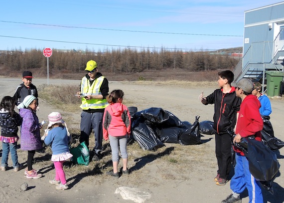 Kuujjuaq is cleaning up: here kids get garbage bags June 7 with recreation animator Collin Suppa (in yellow vest), acting as a supervisor for the clean up in the downtown portion of town. For each bag they collect: $2 a bag and a chance to win 12 bicycles, a Playstation 3, $500 cash prizes and more. The clean-up effort continues all weekend. (PHOTO BY ISABELLE DUBOIS)