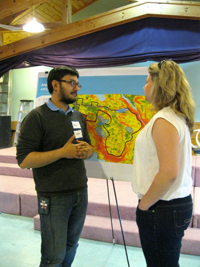 Arif Sayani, director of urban planning and development for the City of Iqaluit, chats with Robyn Campbell, the city’s sustainability coordinator, June 19 at an open house session on future development. Dozens of city residents shared their ideas on two sections of vacant land slated for residential, commercial and institutional development. (PHOTO BY PETER VARGA)