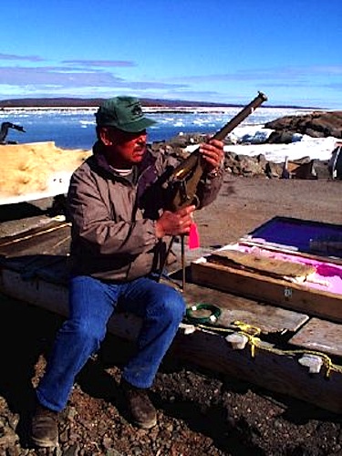 Simeonie Keenainak poses in 1998 with a limited edition reproduction of a 19th century whaling gun, crafted in the United States for use by Alaskan whalers. Keenainak, captain of the 1998 bowhead whale hunt, is also leading the community's 2013 bowhead whale hunt. (FILE PHOTO)