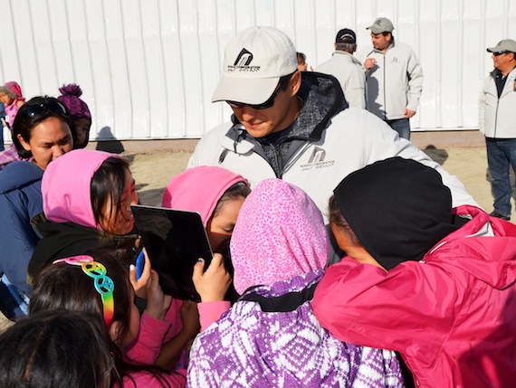 A group of girls gather around their idol Jordin Tootoo, the only Inuk National Hockey League player, July 27 outside Tuqqayaaq Inuuyaq Arena in Clyde River. Tootoo visited Kimmirut, Qikiqtarjuaq, Clyde River, Cape Dorset and Sanikiluaq this past week as part of the 2013 Nunasi Corp. Community Tour. In the communities, Tootoo spoke about the importance of education and how he overcame many obstacles to get where he is today. Read more about Tootoo's tour on Nunatsiaqonline.ca. (PHOTO BY DAVID MURPHY) 