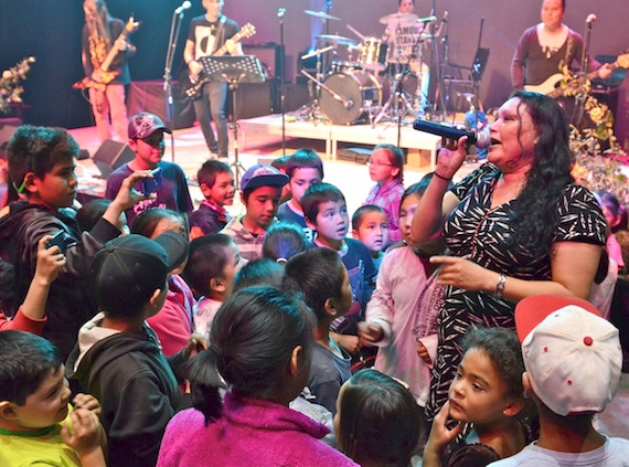 Greenlandic singer Dida Heilmann, surrounded by young members of the audience Aug. 15 at the Aqpik Jam in Kuujjuaq, performs with her band the Rock Stones. For more photos from the Aqpik Jam, which wrapped up Aug. 15, go to the Facebook page of Nunatsiaq News. (PHOTO BY ISABELLE DUBOIS)
