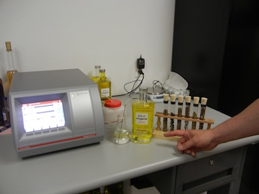 Test tubes holding various plants from Nunavik stand next to a device that measures the alcohol content of the gin, Ungava, produced in Cowansville, a southern Quebec town about an hour's drive southeast of Montreal. (PHOTO BY JANE GEORGE)