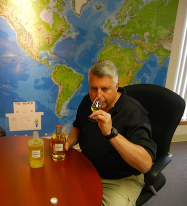 Charles Crawford, president of Domaine Pinnacle, samples his product, Ungava gin, in front of a map which shows the many places where the gin is sold. (PHOTO BY JANE GEORGE)
