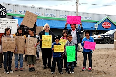 A small group of protesters gather outside the Northmart store in Iqaluit on August 25, 2012 — the last time that the Feeding My Family group urged people in Nunavut to demonstrate against the high cost of food in the territory. (FILE PHOTO)