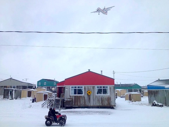 Snow comes to Nunavik: an Air Inuit Dash-8 flies over some homes in Puvirnituq this past weekend after the community received its first serious dusting of snow — enough for kids to build snowmen, but not enough for resident of this Hudson Bay community to take out their snowmobiles. (PHOTO BY MUNCY NOVALINGA)