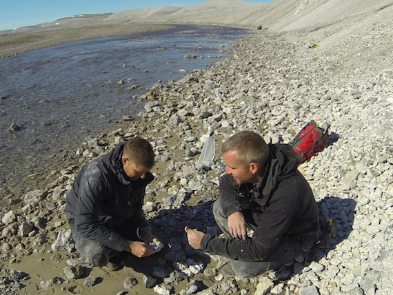 University of Western Ontario professor and geologist Gordon Osinski (right) gives Canadian Space Agency astronaut Jeremy Hansen (left) a test on Devon Island, Nunavut, this past July — he gives Hansen 20 rocks and tells him Hansen can only bring back 10. This is a valuable exercise to learn so that if Hansen travels to Mars or to the moon, he will know which rocks to look for to bring back, and not waste precious space on a tiny shuttle. Read more about Hansen's trip to Devon's Haughton Crater later on Nunatsiaqonline.ca. (PHOTO COURTESY OF J. HANSEN/CANADIAN SPACE AGENCY)