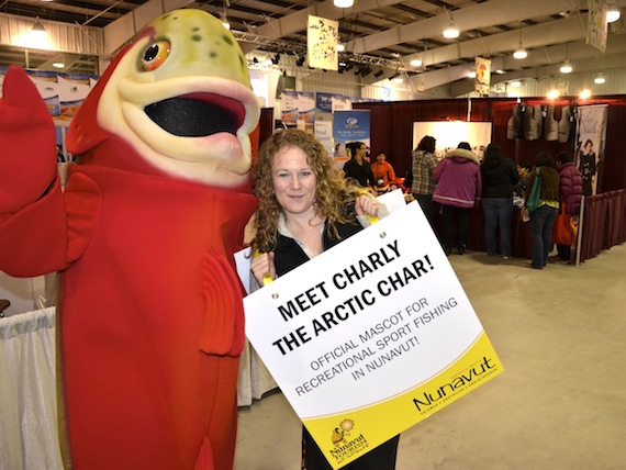 Make new friends: meet Charly the Arctic Char and Sara Acher of Nunavut Tourism who roam around the Nunavut Trade Show at the Arctic Winter Games Arena in Iqaluit. The trade show opens to the public Sept. 26 at 11 a.m. (PHOTO BY DAVID MURPHY)