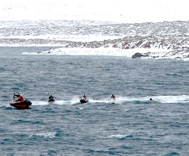 The rescue of a group of American jet-skiers in the Northwest Passage, shown here with a zodiac from the CCGS Sir Wilfrid Laurier Sept. 3, sparks questions in the Nunavut legislature on Sept. 5. (FILE PHOTO)