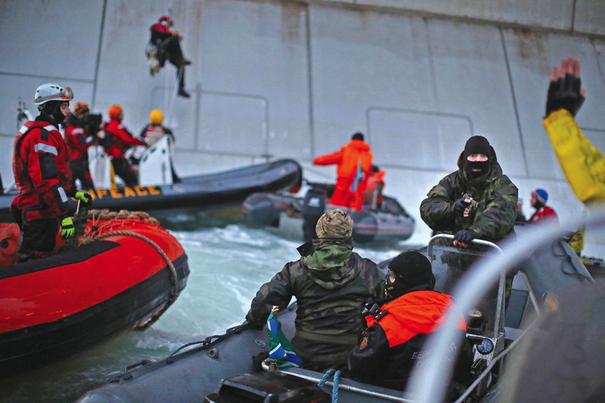 Greenpeace protesters getting arrested as they attempt to board the Gazprom Arctic oil platform. (FILE PHOTO)
