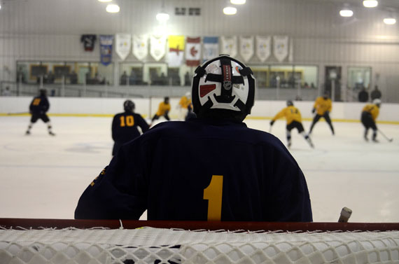 A goalie looks on as his team skates up ice at a scrimmage held Oct. 24 at the Arctic Winter Games Arena in Iqaluit. It's an anxious time for a group of 40 midget hockey players gathered from across the territory for a selection camp. The 40 under-18-year-olds are trying out for Team Nunavut, which will compete at the 2014 Arctic Winter Games. Evaluations will begin Oct. 25 at 10:00 a.m., and there will be eight games over the weekend before cuts are made Oct. 27. The Arctic Winter Games will be held in Fairbanks, Alaska, from March 15 to 22 in 2014. (PHOTO BY DAVID MURPHY)