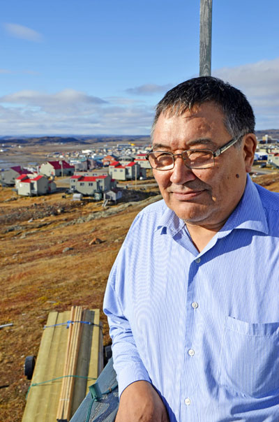 Methusalah Kunuk stands on his patio overlooking Iqaluit Oct. 1. He's running for MLA in the newly-established constituency of Iqaluit-Niaqunnguu. (PHOTO BY DAVID MURPHY)