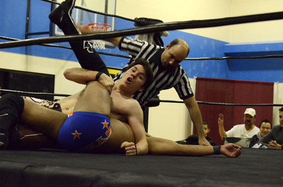 Two wrestlers throw down at the Rumble in the Tundra event Oct. 25 at Inuksuk High School in Iqaluit, Nunavut. Smash Wrestling is in town with several former World Wrestling Entertainment professionals to help raise money for students at the high school for an upcoming trip to Peru. The wrestlers also appeared at schools to give presentations on bullying, nutrition and exercise. An encore performance of the show will take place Oct. 26 at the high school starting at 7 p.m. (PHOTO BY DAVID MURPHY)