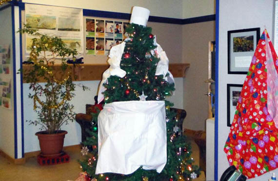 Staff and students at the Nunavut Arctic College campus in Cambridge Bay got a start to the holiday season by decorating their holiday tree like a culinary student, dressed in a chef's hat and apron. Culinary arts is one of the programs hosted at that community's NAC campus. (PHOTO COURTESY OF NAC) 
