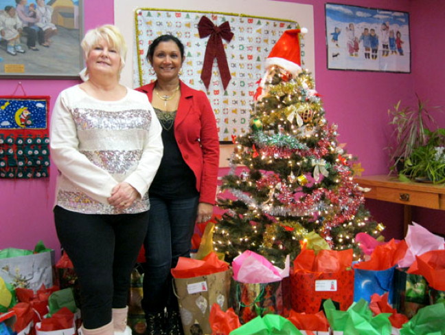 Suny Jacobs, executive director of YWCA Agvvik Nunavut, right, and Rosemary Wall, director of the Qimaavik women’s shelter, with the first batch of gifts they prepared Dec. 11 for the YWCA’s Christmas Eve dinner, Dec. 24 at the community soup kitchen. Though Agvvik, which runs the two Iqaluit women's shelters, caters to female clients, the Christmas dinner is open to everyone. Read more on nunatsiaqonline.ca. (PHOTO BY PETER VARGA)
