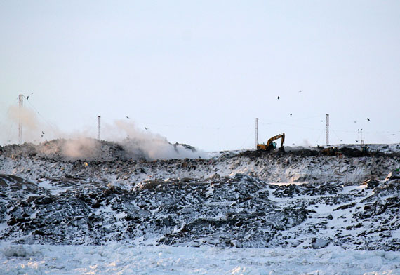 Steam billowed from smouldering hot spots in Iqaluit's overflowing garbage dump just before noon Dec. 12, following a fire that kept fire-fighters busy from about 2:00 a.m. to 7:15 a.m. Iqaluit's municipal enforcement department has closed the West 40 road today and the city asks residents not to take garbage to the dump. It's not clear when the facility will re-open. (PHOTO BY PETER VARGA)