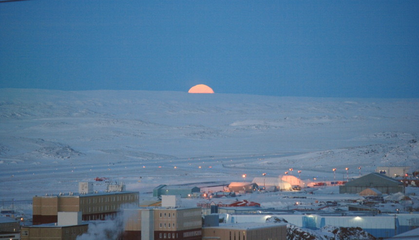 Full moon fever: the view from the Arctic Circle Dental Building in Iqaluit just before sunrise on the morning of Jan. 17 as the full moon sets below the horizon. That's the Iqaluit airport runway in the distance. (PHOTO BY PETER VARGA)