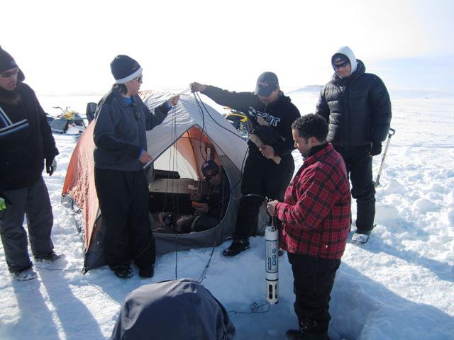 Second-year students in Arctic College's Environmental Technology Program learn how to use a hydrolab from Jamal Shirley, in red and black plaid, at a limnology field camp at Crazy Lake, outside of Iqaluit, in April 2013. (PHOTO COURTESY OF ETP)