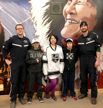 Collin Goyman, left, and co-worker Chris Hillary of Advanced Medical Solutions’ medevac service in Cambridge Bay awarded hockey memorabilia prizes Feb. 7 to Kiilinik High School students Nigel Tologanak, Lutaya Uttak and Dean Evetalegak as part of the school’s “Got Ya” program. (PHOTO COURTESY OF COLLIN GOYMAN)