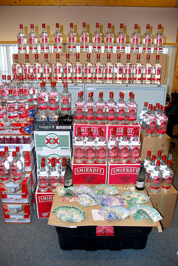 A big inventory of beer and Smirnoff vodka seized in Iqaluit by police in March 2010, when four Iqaluit men were charged with keeping liquor for sale illegally. The men had acquired the booze legally, but intended to sell it illegally. (FILE PHOTO)