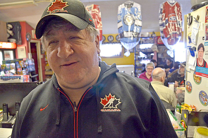 Brian Twerdin, co-owner of Iqaluit's Grind and Brew cafe, got dressed up for Team Canada's first men's hockey game against Norway Feb. 13 and put the game on his flat screen TV so customers could watch. Canada won the game 3-1 with a performance some sports pundits described as lackluster. Canada's dream team, which won Olympic gold in Vancouver four years ago, continues their quest for the podium in Sochi when they play Austria Feb. 14 at noon Eastern time. (PHOTO BY DAVID MURPHY) 
