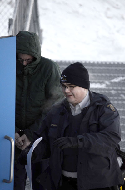 Eric Dejaeger is led into an RCMP vehicle following a court appearance at the Nunavut Court of Justice in Iqaluit. (FILE PHOTO)