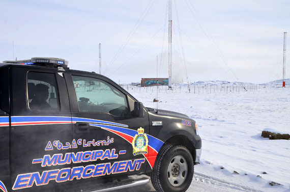 A City of Iqaluit municipal enforcement truck blocks the West 40 road that leads past he burning Iqaluit dump around 2:30 p.m. March 27. The City of Iqaluit said the fire started around 1 p.m. and 