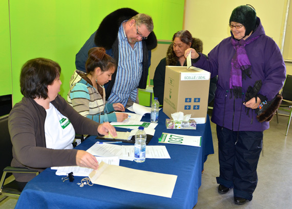 Kuujjuaq resident Martha Greig, right, casts her ballot at the polling station set up in the northern village office April 7, in front of deputy returning officer Anne Trudeau and poll clerk Arnaujaq Koneak, at left. Polls are open in each Nunavik community and throughout Quebec today until 8:00 p.m. (PHOTO BY ISABELLE DUBOIS) 
