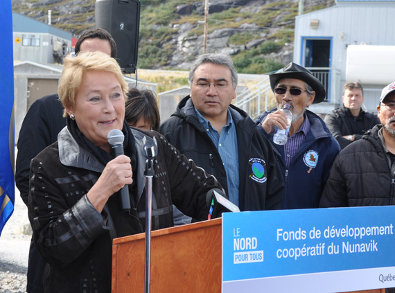 Quebec premier Pauline Marois, flanked by Makivik president Jobie Tukkiapik, speaks to a crowd in Kangisualujjuaq in September 2013. Makivik thanked the outgoing premier April 8 for her work on behalf of the Inuit of Nunavik. (PHOTO BY SARAH ROGERS) 