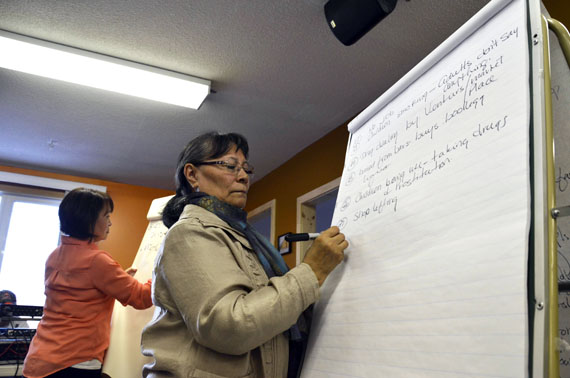 Myna Ishulutak, left, and Rebekah Williams jot down suggestions from the public at a meeting related to the Government of Nunavut's Crime Prevention Strategy May 1 at the Catholic Parish Hall in Iqaluit. More than 50 people turned up for the meeting, including RCMP officers, Iqaluit municipal enforcement staff, MLAs and justice officials. Participants shared their concerns about community safety and how to tackle crime in Nunavut's largest centre. Read about the meeting later on Nunatsiaqonline.ca. (PHOTO BY DAVID MURPHY) 