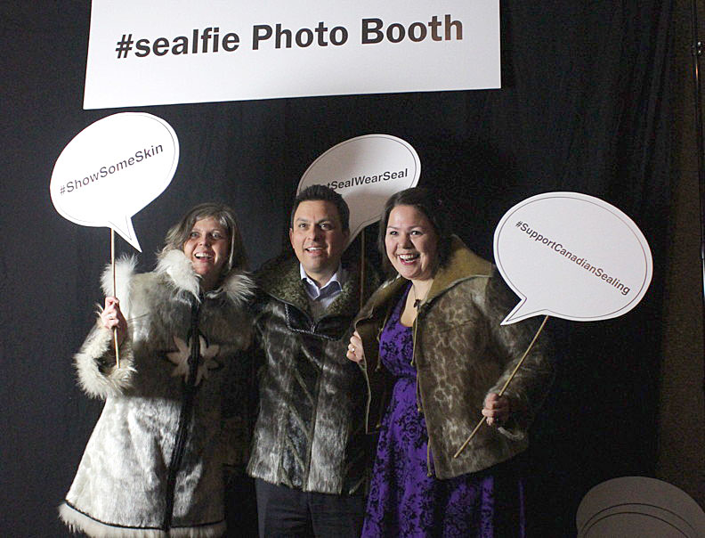 Assembly of First Nations staffers slipped on some skin at the Inuit Tapiriit Kanatami's #sealfie photo booth in Ottawa, which, aside from the seal meat martinis, was the most popular attraction at the ITK's A Taste of the Arctic annual celebration of Inuit food and culture April 7. From left, Karen Campbell, director of research and policy coordination, Peter Dinsdale, assistant chief executive officer, and Kathy Kettler, policy analyst. The event, held at the National Arts Centre, attracted a number of Ottawa power brokers including federal ministers, senators and at least two Nunavut MLAs. Read more later on nunatsiaqonline.ca. (PHOTO BY LISA GREGOIRE)