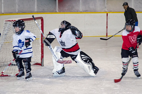 A Cambridge Bay minor hockey league goaltender makes a big save April 30. Minor league players from about four to ten years old faced off against their parents and coaches in the league's final game of the season the same evening. The senior players put in a strong effort, but the minors won 16-15. (PHOTO BY DENISE LEBLEU IMAGES)