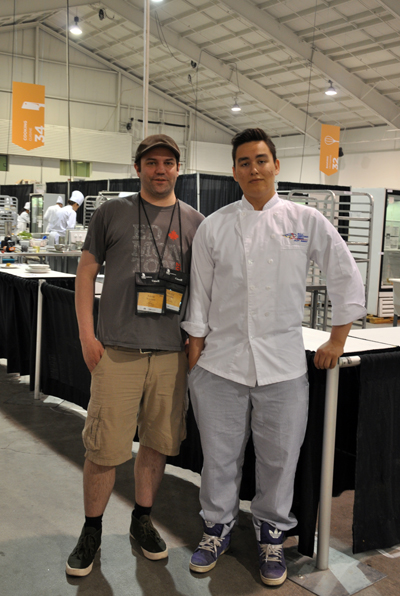 Skills Iqaluit cooking club coach Aaron Watson, left, with competitor Simeonie Kisa-Knickelbein in front of the Skills Canada cooking station at the International Centre in Mississauga, Ont. (PHOTO BY SARAH ROGERS) 