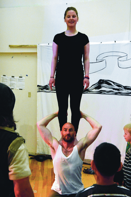 Guillaume Saladin, performer, trainer and co-founder of Artcirq — Igloolik’s travelling acrobatic circus clan — holds a participant from the June 29 circus workshop on his shoulders at Nakasuk School in Iqaluit. (PHOTO BY DAVID MURPHY) 