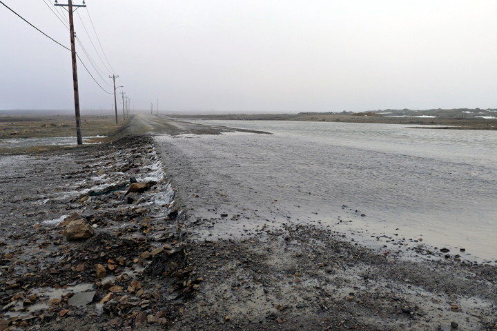 Cambridge Bay resident Denise LeBleu snapped this shot of the Airport Road June 18 after heavy rains overnight on top of melting snow caused flooding in some areas of that Kitikmeot community. Mitik Street was also flooded out and low lying areas turned into ponds. Environment Canada's website said roughly half a centimetre of precipitation fell June 18. (PHOTO BY DENISE LEBLEU)