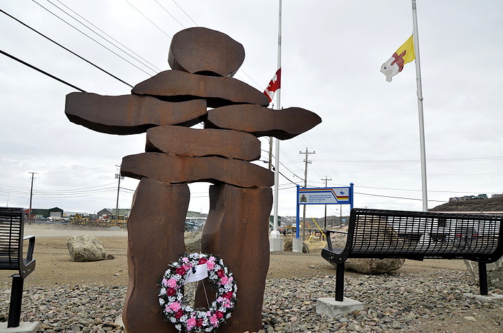 Flags flew at half-mast in Nunavut June 10, including here at the Iqaluit RCMP detachment, for the funeral of three fallen New Brunswick RCMP officers: constables Fabrice Georges Gevaudan, 45, Douglas James Larche, 40, and Dave Joseph Ross, 32. The three officers died after a shootout with a Moncton man who now faces three charges of first-degree murder, as well as two counts of attempted murder. Nunavut department of corrections laid a wreath at the foot of an Inukshuk at the detachment and left a note attached. 