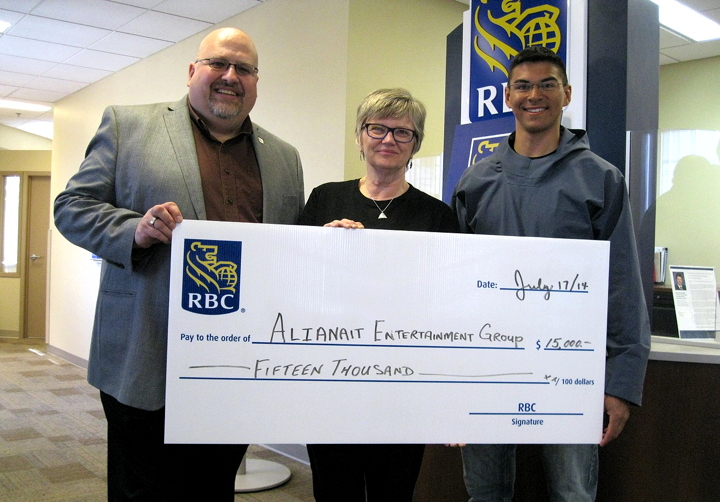 Alianiat Entertainment Group’s emerging artists program got a boost from RBC Royal Bank, July 17, when the bank’s regional vice-president for Canada’s three territories, Jeff T. Fowler, left, presented a cheque of $15,000 in support of the program. Heather Daley, executive director of Alianait, and Franco Buscemi, chair of the group’s board of directors, received the cheque in a small ceremony at RBC’s branch in Iqaluit. “We work with a lot of emerging Nunavut artists,” Daley said of Alianait’s program, which supports young Nunavummiut seeking to start careers in the music industry. “This helps us get them gigs, and gets them to participate in music industry workshops.” (PHOTO BY PETER VARGA)