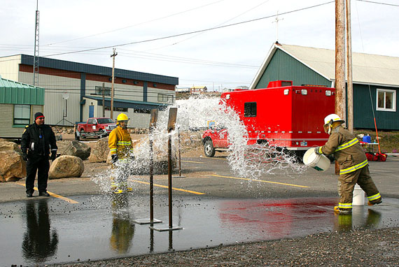 Jonah Akulukjuk, acting fire chief for the fire department in Pangnirtung, hits the target during a bucket relay exercise at the Nunavut Firefighters Competition in Iqaluit Aug. 7. Akulukjuk is one of 15 firefighters from throughout the territory to compete in the annual event, held this year from Aug. 5 to Aug. 10. It's organized by Nunavut’s Department of Community and Government Services, the Nunavut Municipal Training Organization and the Office of the Fire Marshal. The group’s top six competitors will represent Team Nunavut at the National Aboriginal Firefighting Competition in Fort McKay, Alberta, Aug. 12 to Aug. 16. (PHOTO BY PETER VARGA)