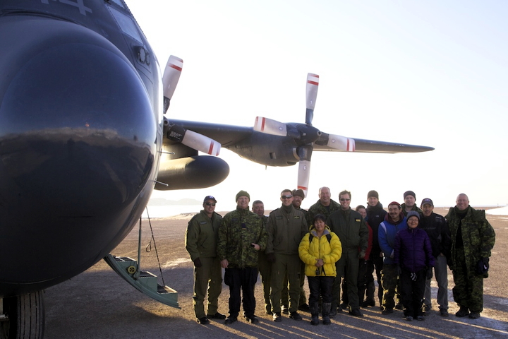 Arctic Bay CASARA members — Leata Qaunaq, Dexter Koonoo, Valerie Qaunaq, and Seemee Tunraq (Clare Kines not pictured) — along with CASARA instructors and members of the Canadian Forces pose for a group photo before boarding the CC-130 Hercules jet. (PHOTO BY CLARE KINES)