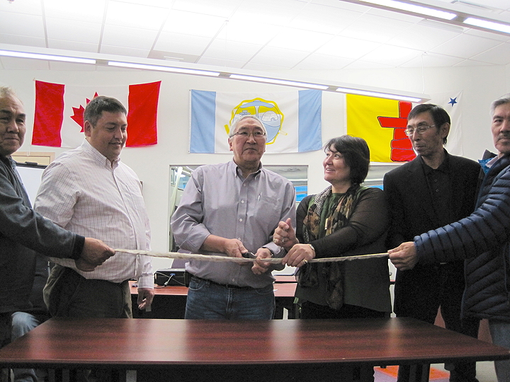 Inuit leaders celebrate the grand opening of the Kitikmeot Inuit Association building Oct. 20 in Cambridge Bay with a ceremonial ribbon cutting in the board room. Open since last November, the imposing 1,869-square-metre building, which has won awards for its design, now has a name, the Fred R. Elias Centre, after the KIA's longtime executive director who died in 2010. The building's board room will now be known as the Pat Lyall board room, after the late Pat Lyall, who was involved in the KIA, Nunasi Corp., Arctic Co-operatives Ltd. and the Inuit Broadcasting Corporation. From left: Larry Audlaluk, acting president of the Qikiqtani Inuit Association, David Ningeongan, president of the Kivalliq Inuit Association, KIA president Charlie Evalik, Cathy Towtongie, president of Nunavut Tunngavik Inc., David Omilgoitok, executive director of the Kitikmeot Corp. and KIA vice president Attima Hadlari. (PHOTO BY JANE GEORGE) 