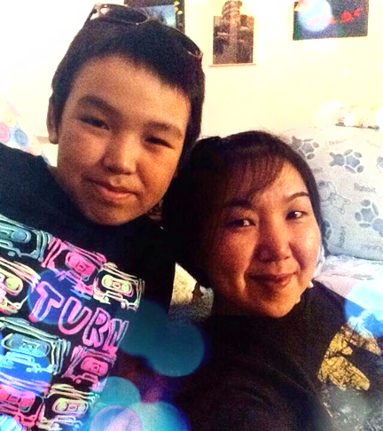 Eileen Arragutainak and her son, Shawn. Arragutainak recently bartered with a southern buyer online to exchange an amautik she made for hockey equipment for Shawn. (PHOTO COURTESY EILEEN ARRAGUTAINAK)