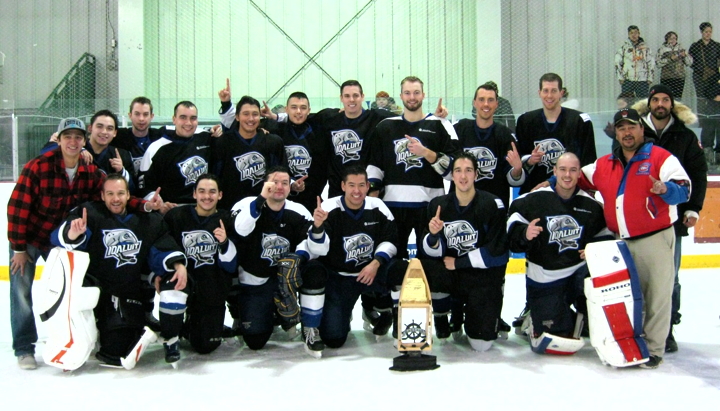 The Iqaluit Icemen celebrate as champions of the inaugural Qaqsauq Cup in the Arctic Winter Games Arena in Iqaluit, Dec.7, after winning a close battle against Yellowknife, 4-2. The home team overtook the Ottawa Redwings by the same score earlier in the day to make it to the finals. Iqaluit’s Nunavut rivals, Rankin Inlet, went undefeated in the three-day tournament until Yellowknife edged them out 5-4 in the semi-finals. The hockey tournament honours the memory of eight Iqaluit men who drowned in Frobisher Bay in 1994 when their vessel Qaqsauq overturned in a storm. Pitseolak Alainga, far right in red, one of two survivors of the disaster, presented the trophy to team captain Dwayne Twerdin, front centre, who also earned the Fred Coman memorial award as the tournament’s most valuable player. (PHOTO BY PETER VARGA)