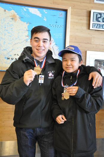 NYHDP coach Gary Joe Angnatuk and Peewee team captain Jimmy Kasudluak show off their gold medals at the Kuujjuaq airport Feb. 23. (PHOTO  BY SARAH ROGERS)